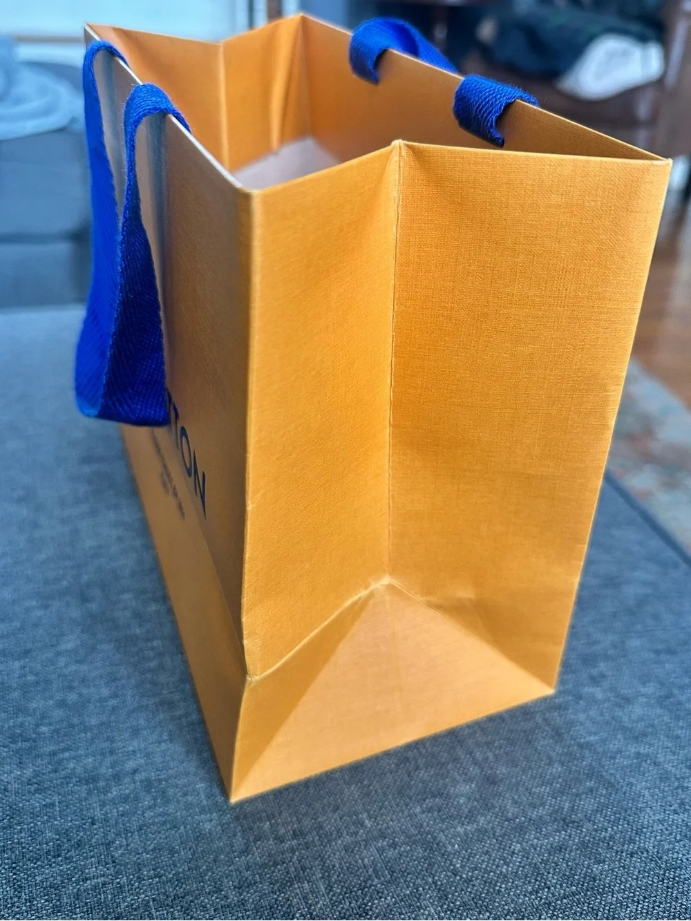 Louis Vuitton Orange Shopping Bag with Blue Handles and Black Logo